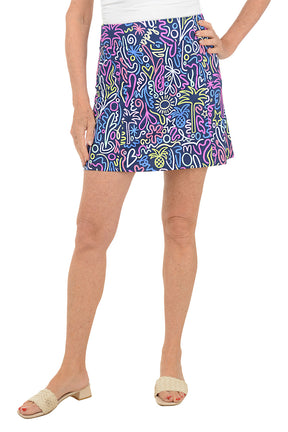 Person wearing a colorful patterned skirt on a white background.