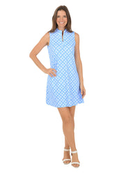 Woman wearing a blue patterned dress on a white background