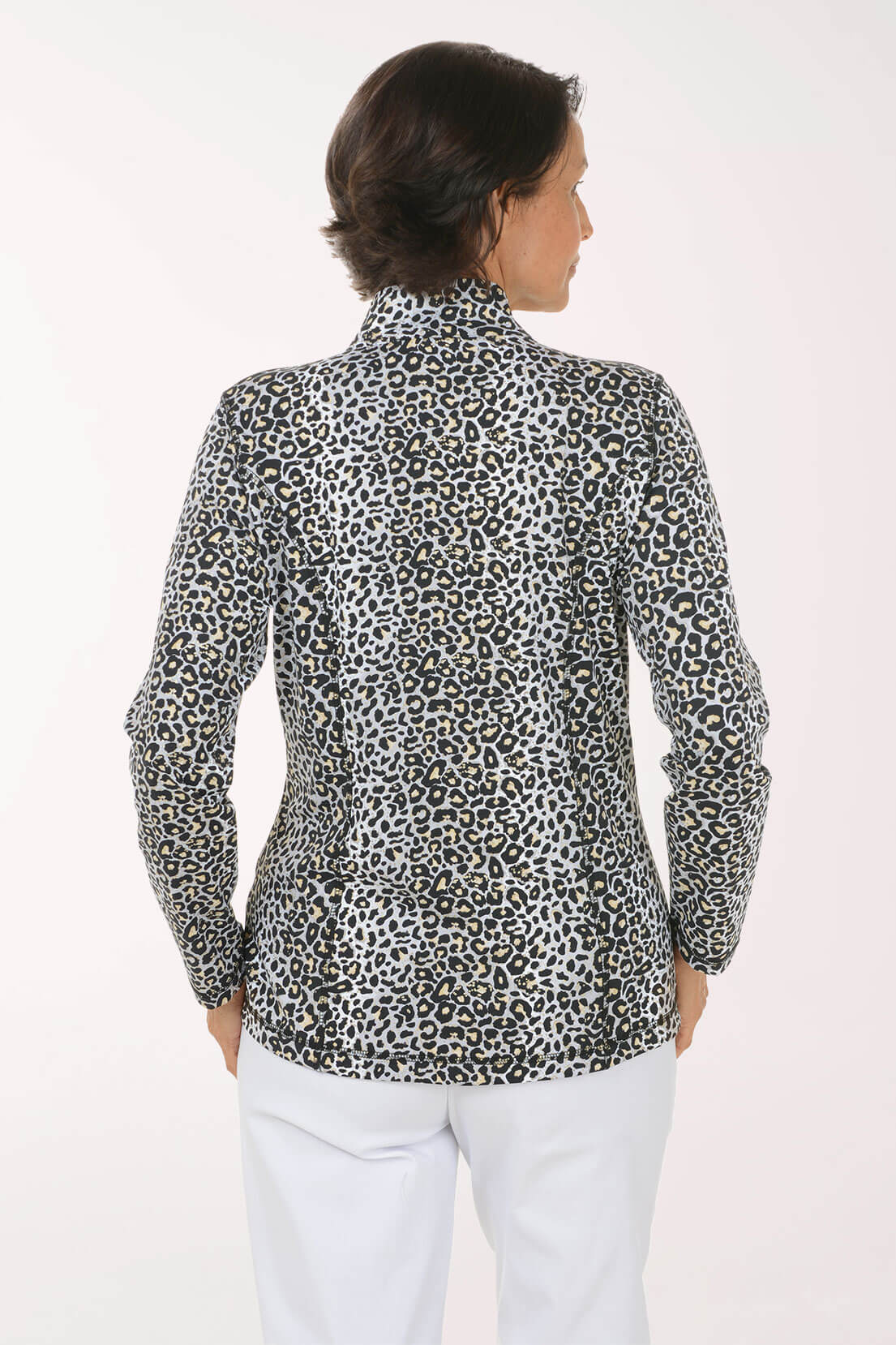 A woman shown from the back wearing a leopard-print blazer with white pants, photographed against a plain light background.