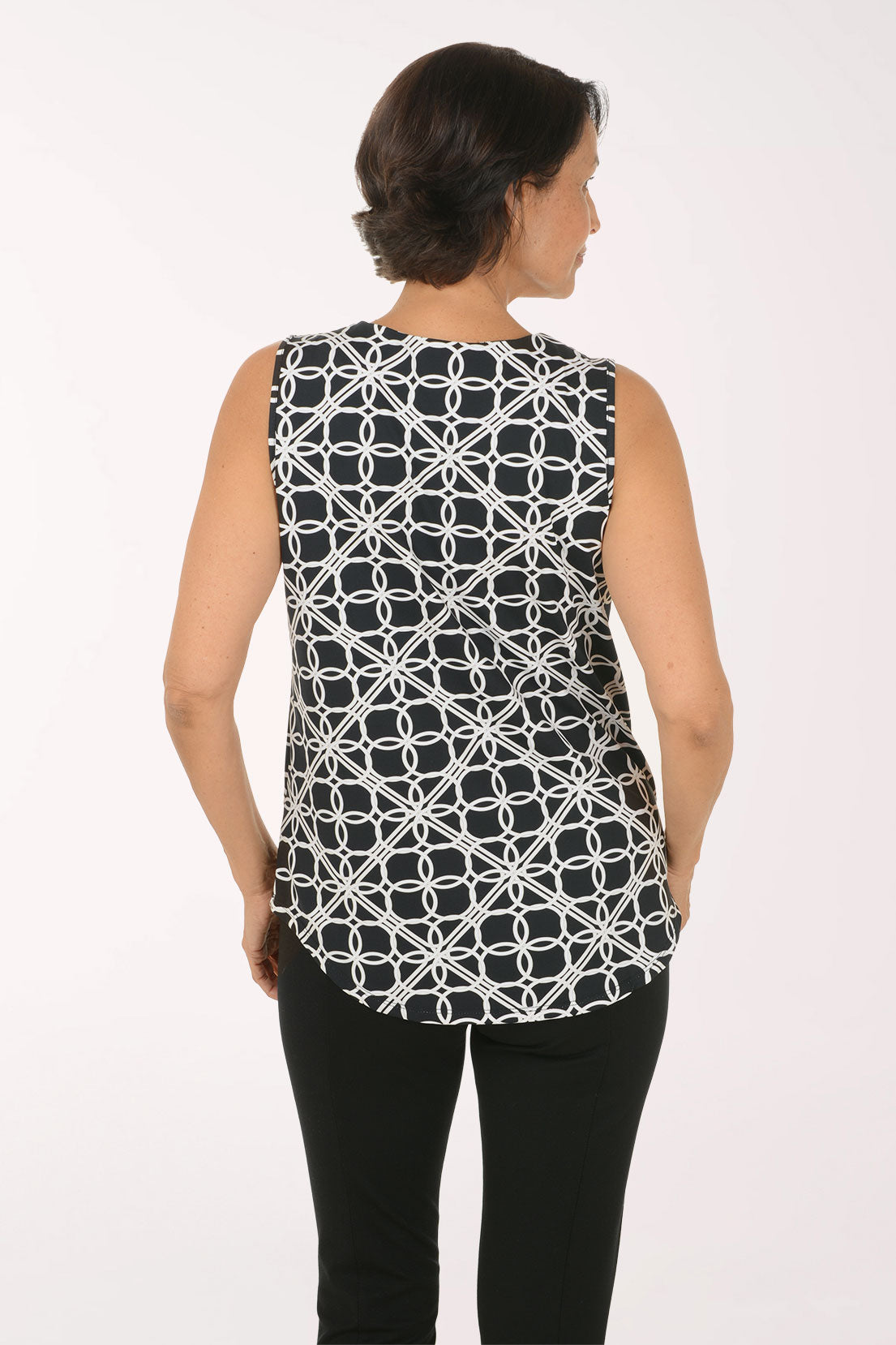 Woman wearing a sleeveless black and white abstract printed top
