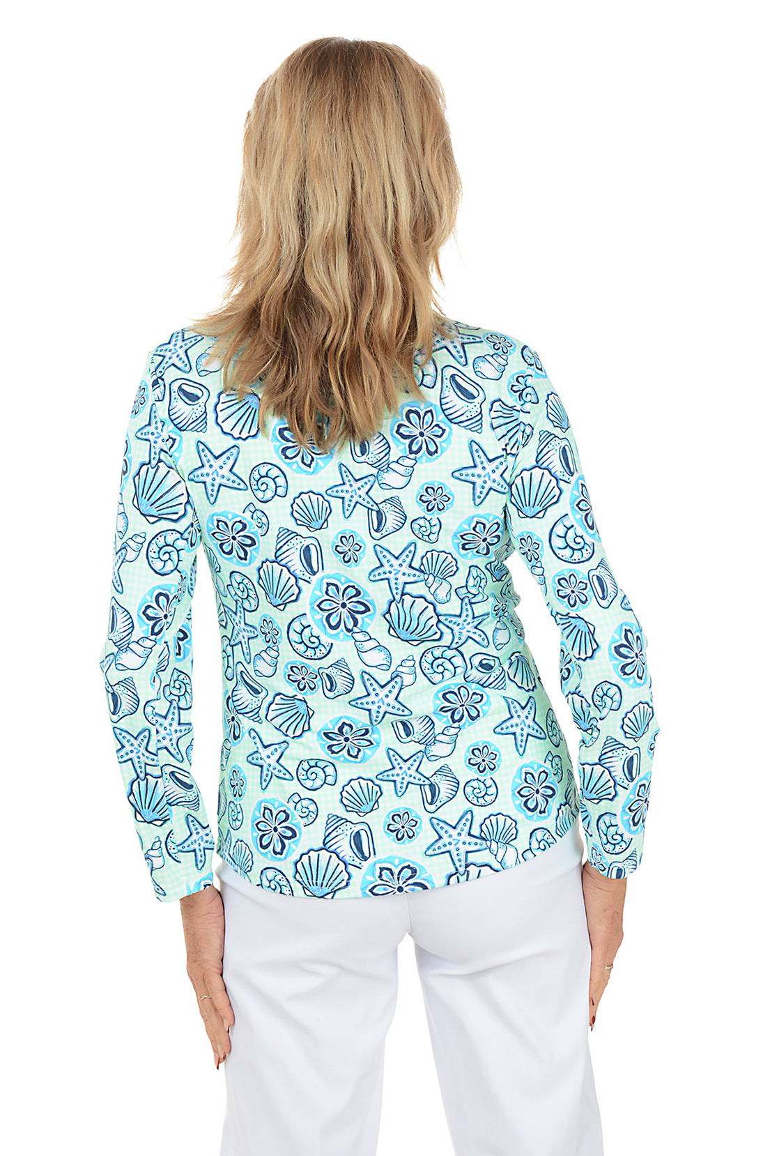 Woman wearing a blue floral patterned blouse on a white background. Back shot.