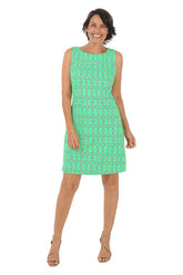 Woman wearing a green patterned dress on a white background