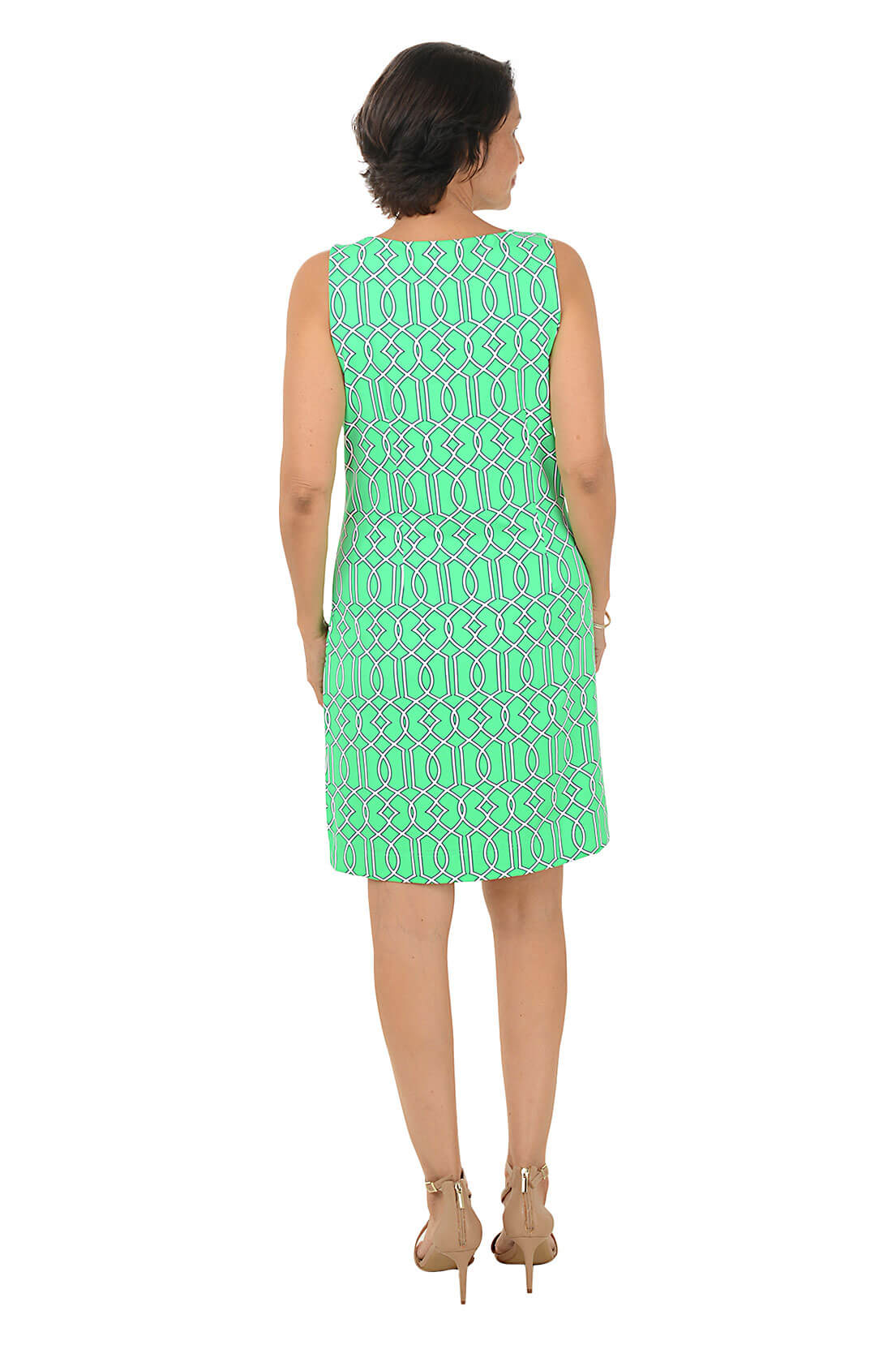 Woman wearing a green patterned dress on a white background