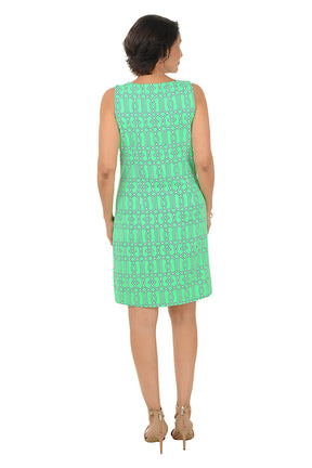 Woman wearing a green patterned dress on a white background