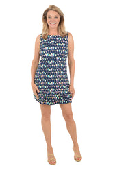 Woman wearing a patterned dress on a white background.