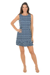 Woman wearing a blue patterned dress on a white background.