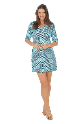 Woman wearing a blue patterned dress on a white background. Second front shot.