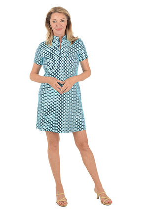 Woman wearing a patterned dress on a white background.