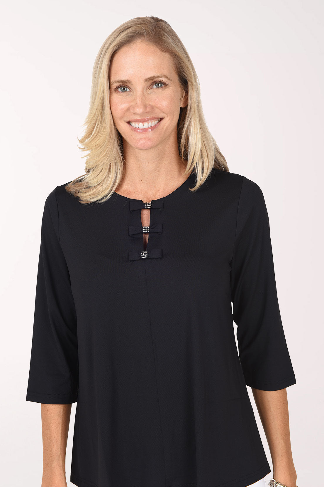 Close-up of the black Crystal Bow 3/4 Sleeve Top showing the three stacked bows with crystal accents at the split neckline.