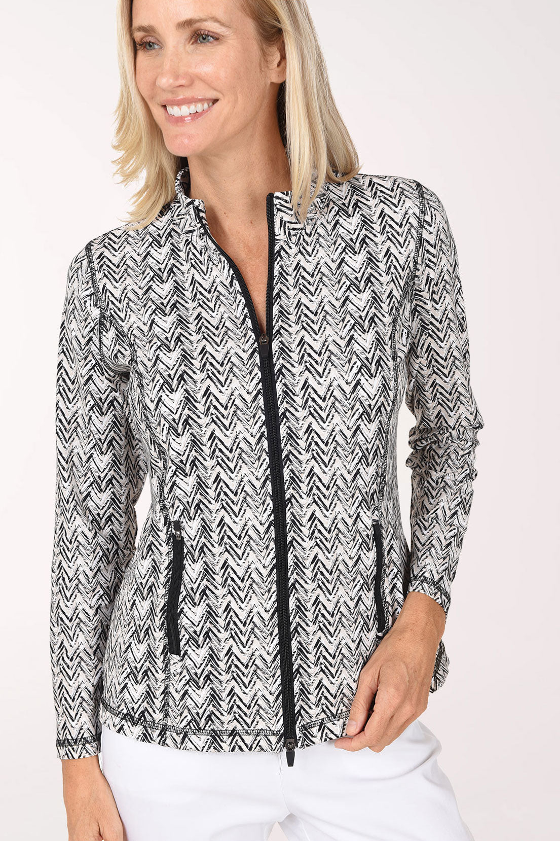 Close-up of the Neutral Chevron Athletic Zip Jacket showing the black and white chevron print, two-way zipper, zip hip pockets and contrast stitched seams.