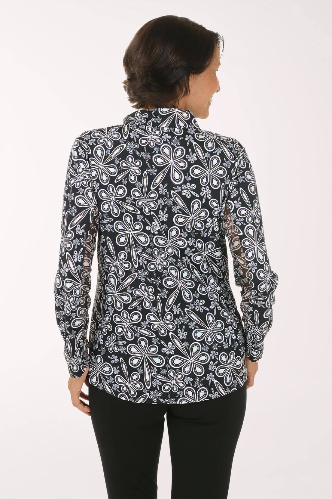Back shot of a model wearing a black and white floral printed sun shirt 