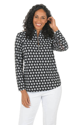 Woman wearing a black and white patterned sun shirt with a zipper on a white background