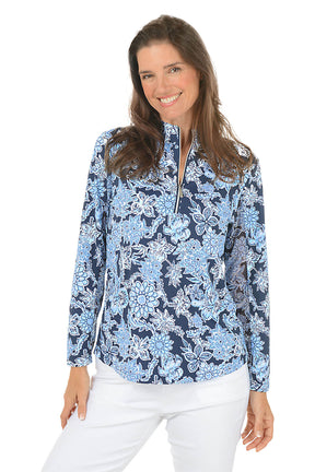 Woman wearing a blue floral blouse with a white background