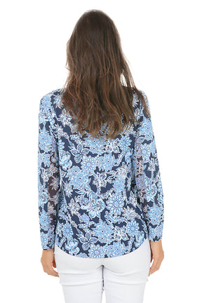 Woman wearing a blue floral blouse on a white background