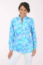 Woman wearing a blue and white patterned shirt on a white background