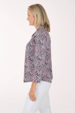 Woman wearing a patterned blouse with a white background