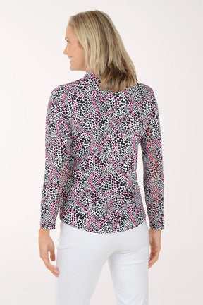 Woman wearing a patterned blouse with a white background