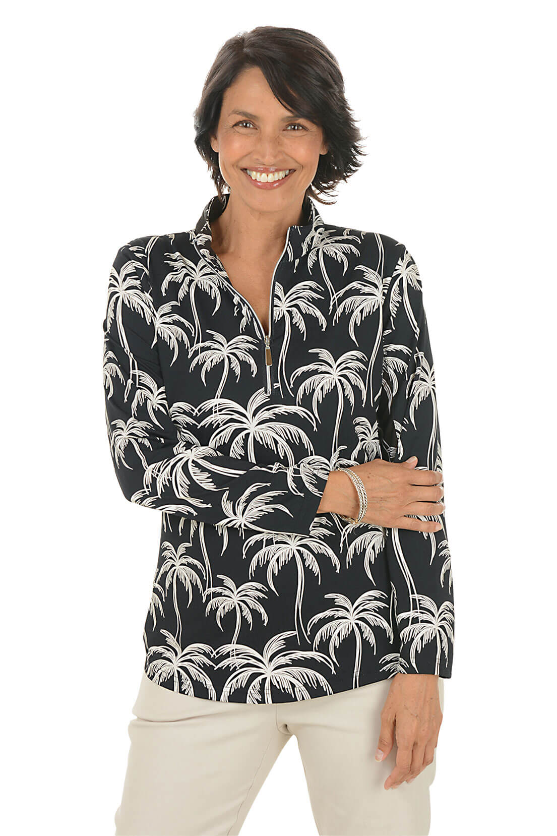 Woman wearing a black long-sleeve shirt with palm tree pattern on a white background