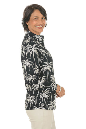 Woman wearing a black shirt with palm tree pattern on a white background