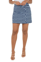 Person wearing a blue and white patterned skirt on a white background