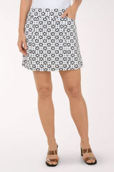 Person wearing a black and white patterned skirt on a white background