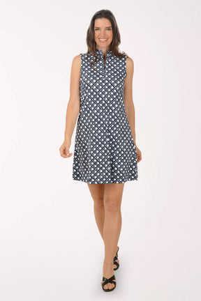 Woman wearing a sleeveless dress with a geometric pattern on a white background