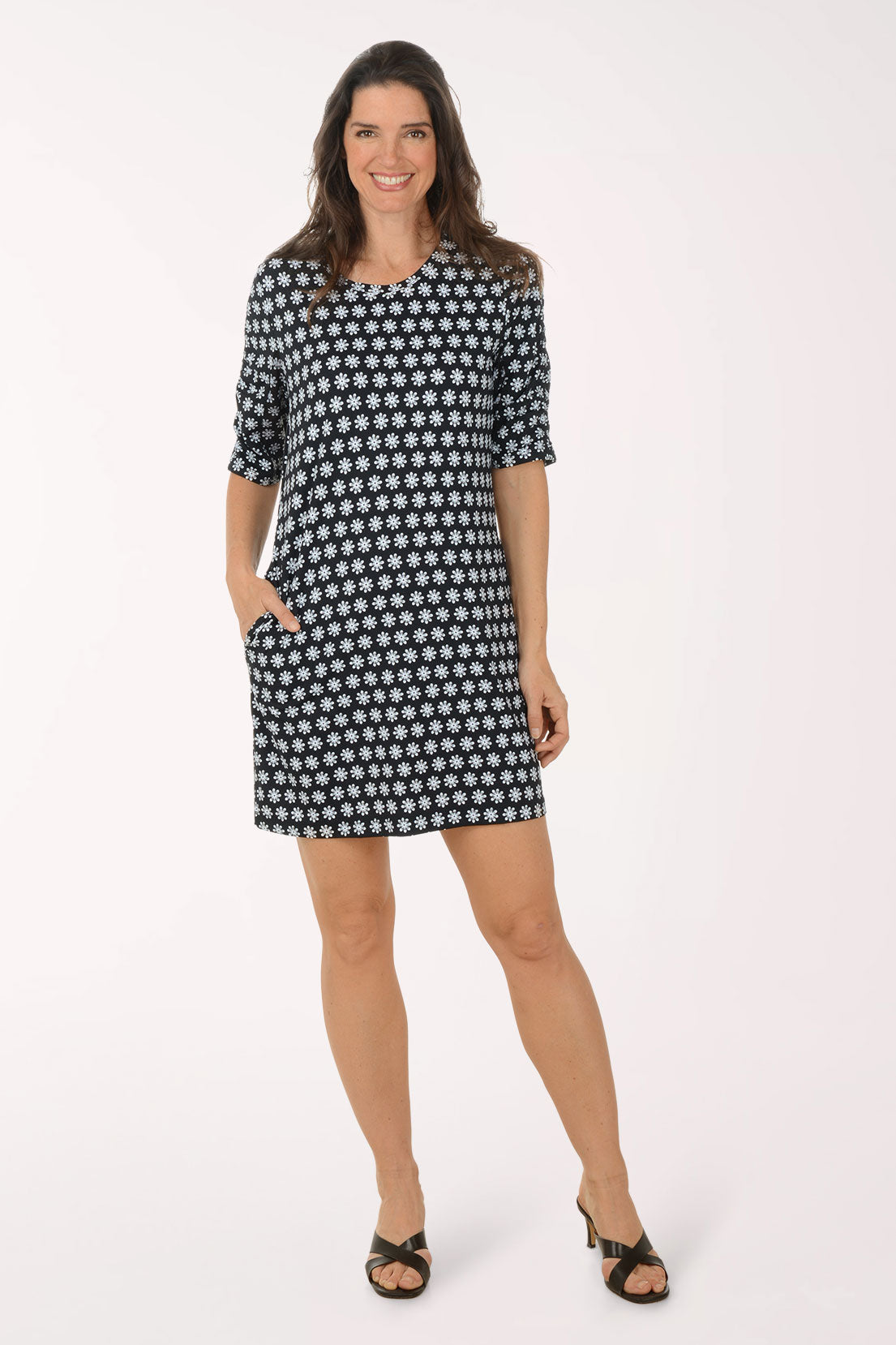 Woman wearing a black and white patterned dress on a white background