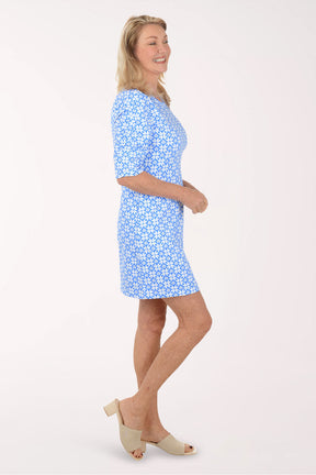 Woman wearing a blue floral dress on a white background