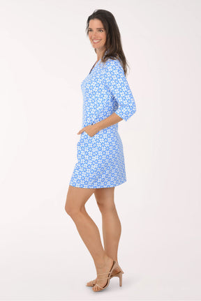 Woman wearing a blue floral dress on a white background