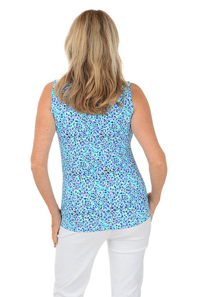 A sleeveless navy and blue floral print top with a mock neckline and zippered half placket. Back shot.