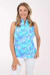 Woman wearing a blue floral sleeveless top against a white background