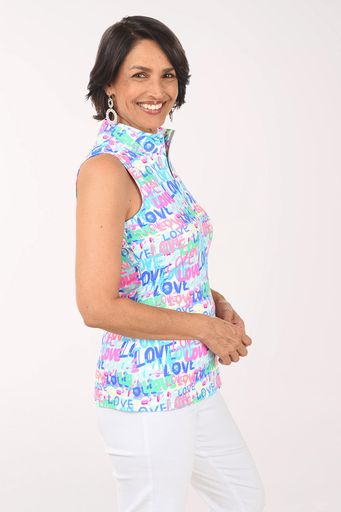 Woman wearing a sleeveless top with 'LOVE' print on a white background