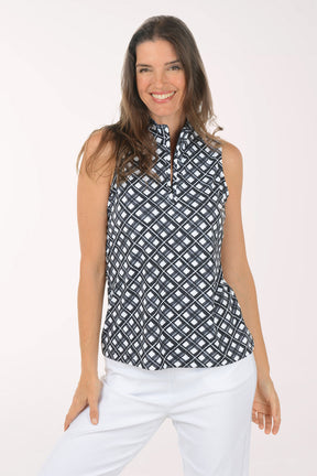 Woman wearing a black and white sleeveless patterned top against a white background