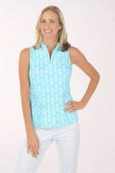 Woman wearing a light blue sleeveless patterned top against a white background