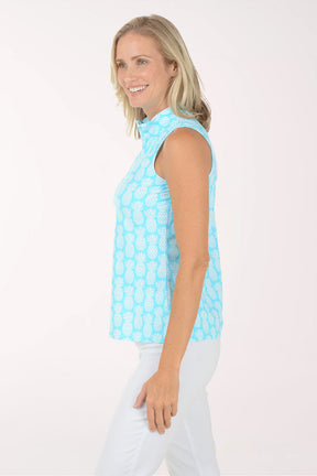 Woman wearing a light blue sleeveless patterned top against a white background