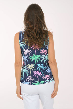 Woman wearing a sleeveless top with colorful palm tree pattern on a white background