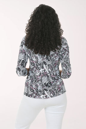 Woman wearing a patterned blouse with a plain background