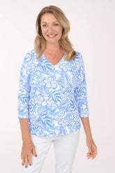 Woman wearing a blue floral patterned shirt on a white background