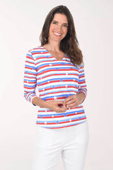 Woman wearing a red, white, and blue striped shirt with a pattern of stars on a plain background