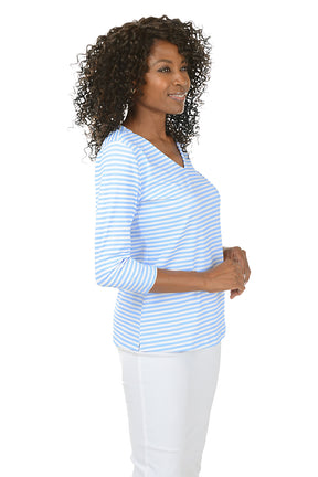 Woman wearing a blue and white striped shirt on a white background. Side shot.