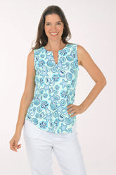Woman wearing a sleeveless top with a blue sea-themed pattern on a white background
