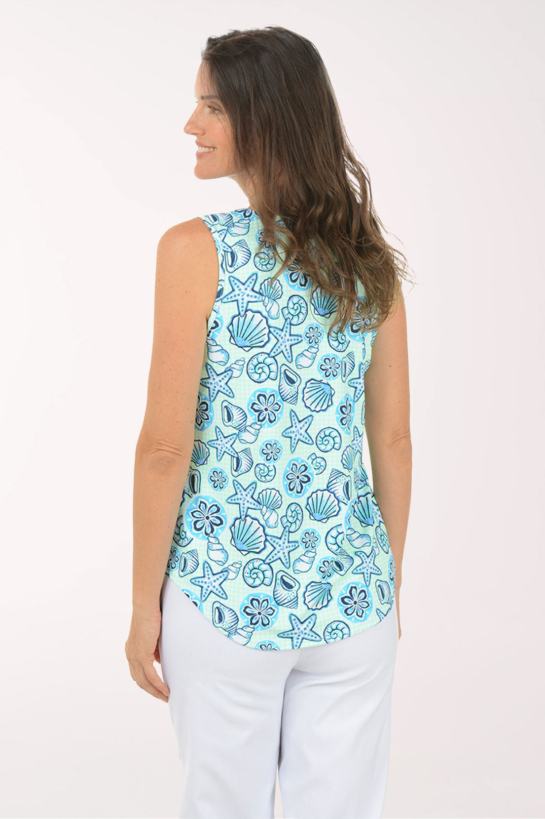 Woman wearing a sleeveless top with a blue sea-themed pattern on a white background