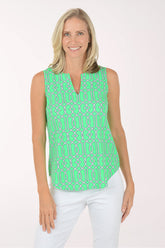 Woman wearing a green patterned sleeveless top on a white background
