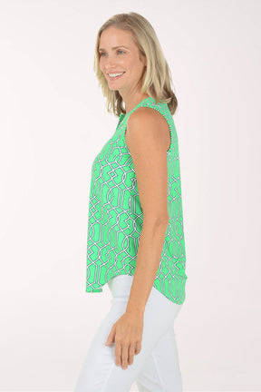 Woman wearing a green patterned sleeveless top on a white background