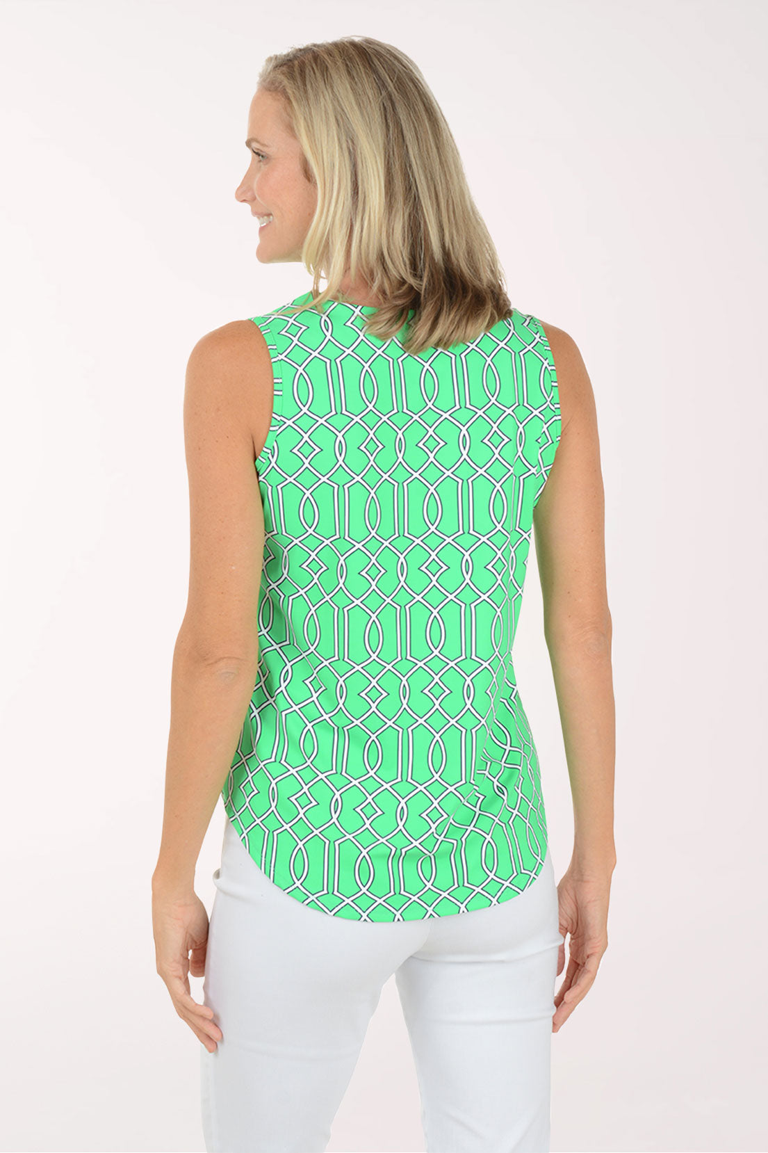 Woman wearing a green patterned sleeveless top on a white background