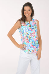 Woman wearing a colorful floral sleeveless top on a white background