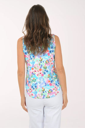 Woman wearing a colorful floral sleeveless top on a white background