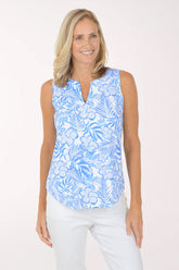 Woman wearing a blue floral sleeveless top on a white background