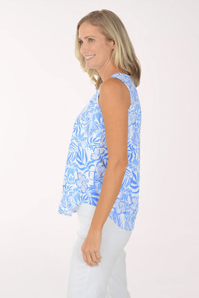 Woman wearing a blue floral sleeveless top on a white background