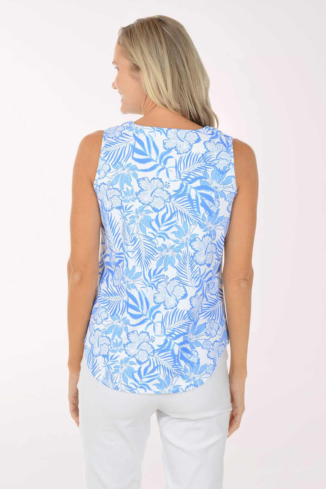 Woman wearing a blue floral sleeveless top on a white background